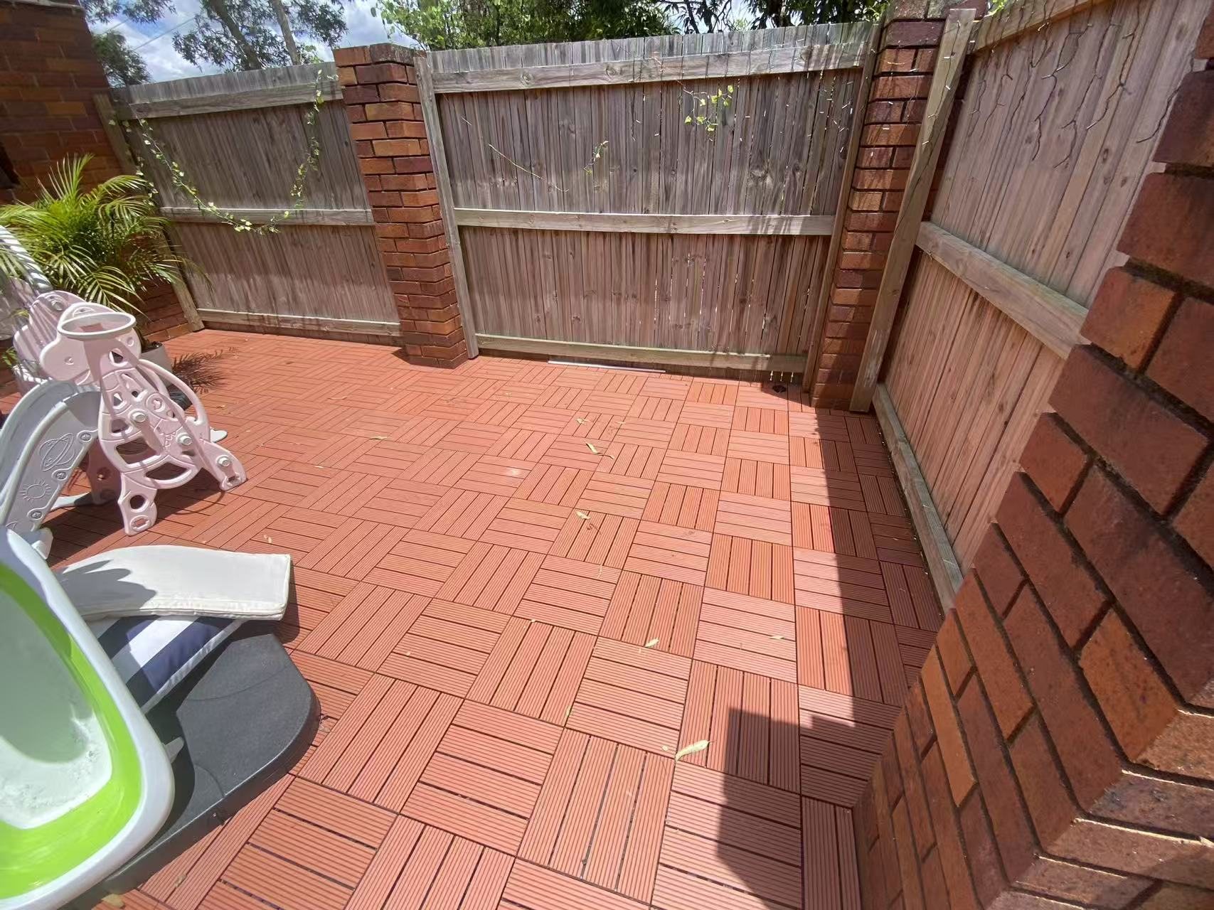 Edge detail where the deck tiles meet the surrounding surface.