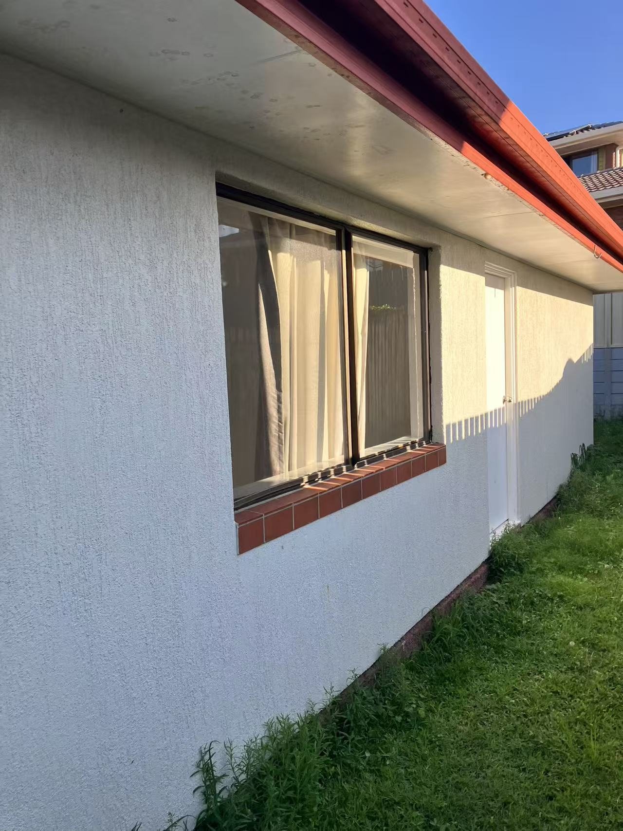 Side window during flyscreen installation on the house exterior.