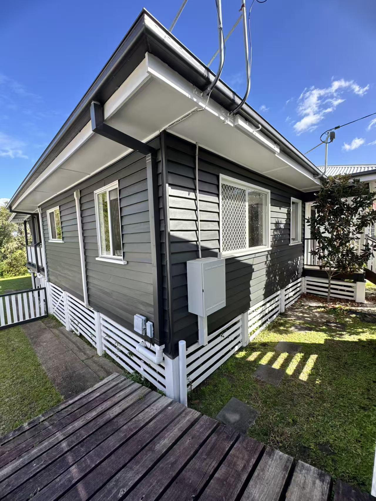Side view of the same home showing the repainted exterior wall surface.