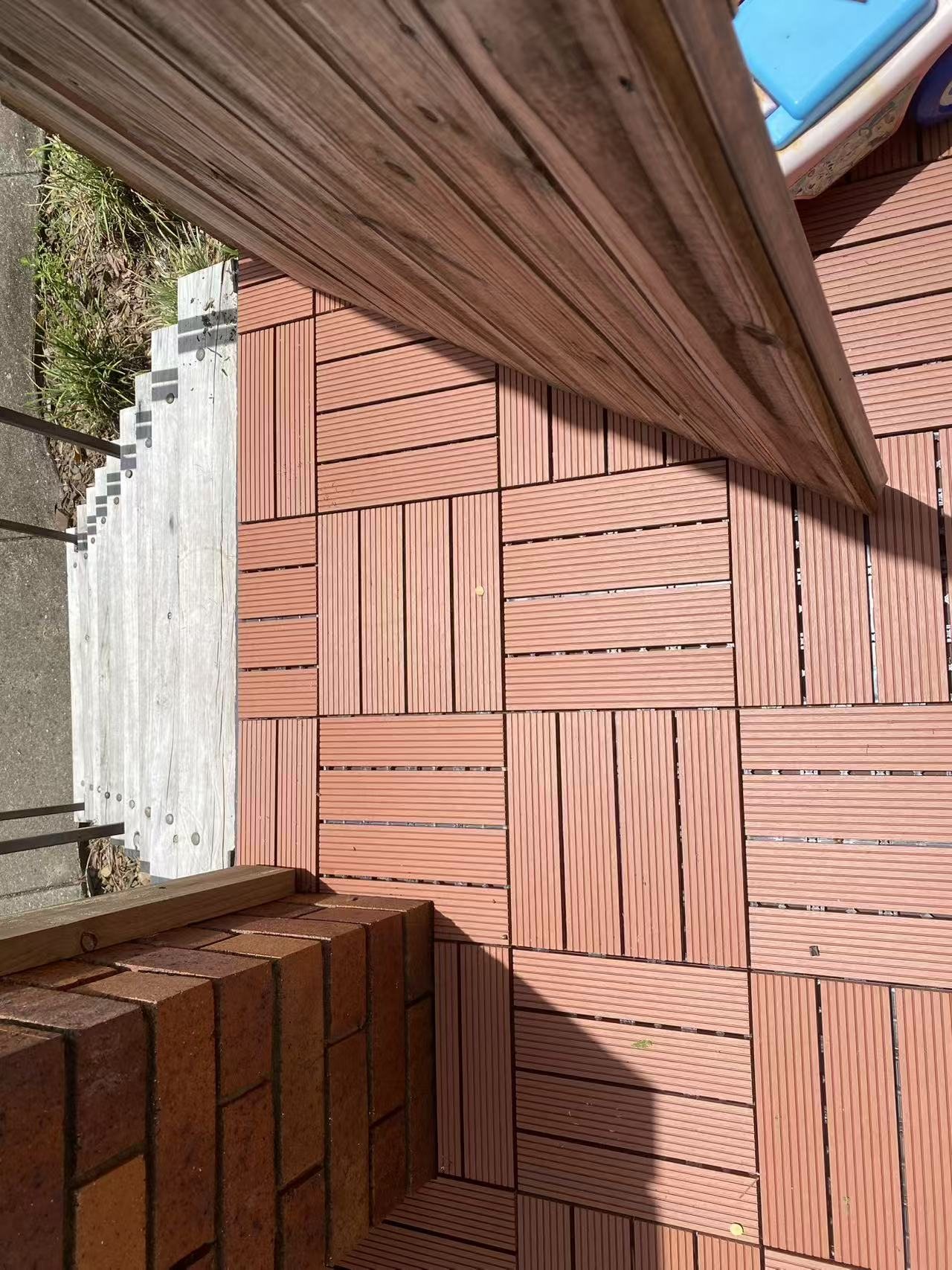 Corner detail of the modular deck tiles in the outdoor area.