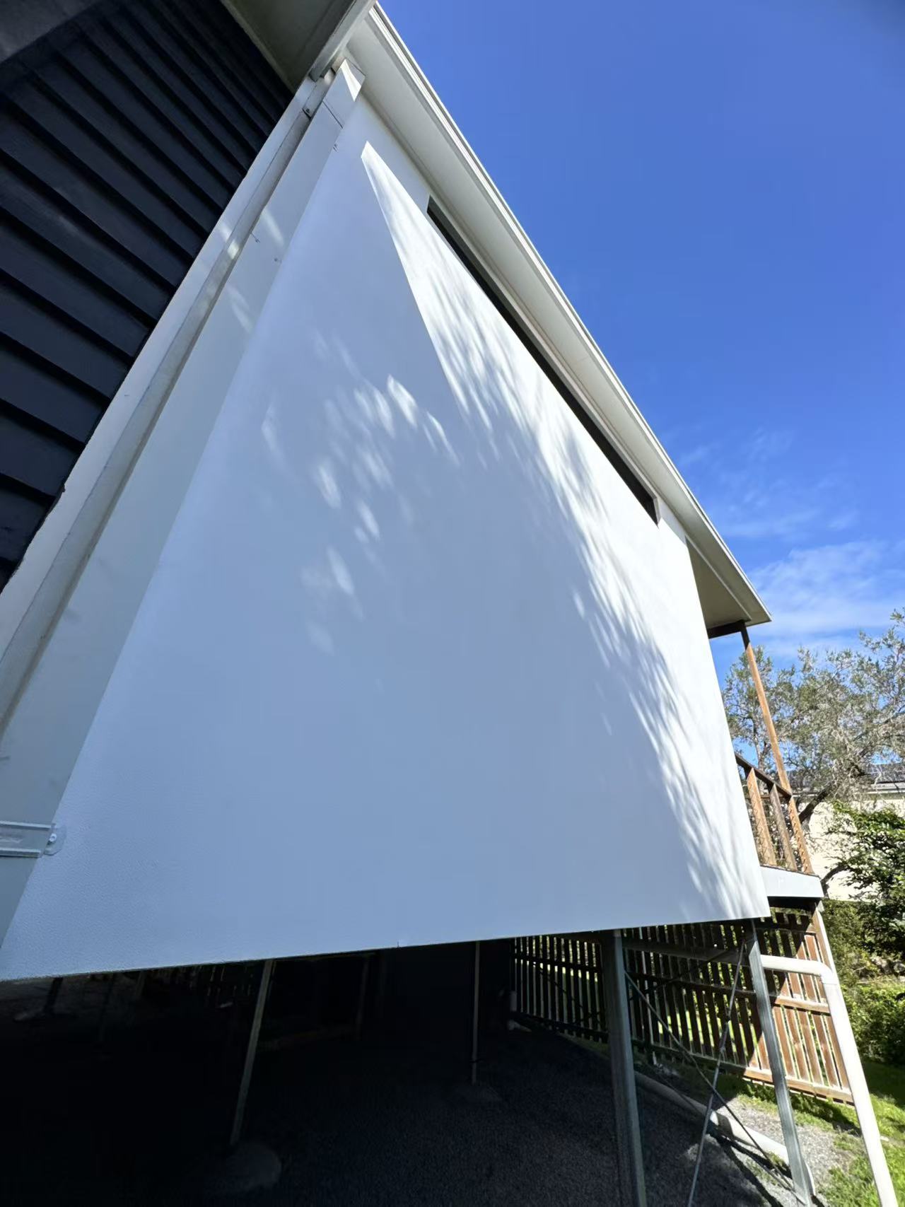 Close-up of a repainted white exterior wall section.