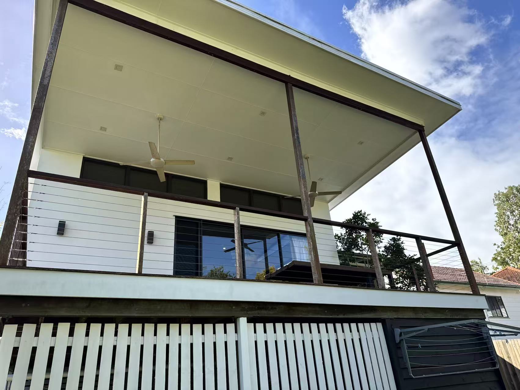 Front balcony view showing the repainted railings and wall behind.